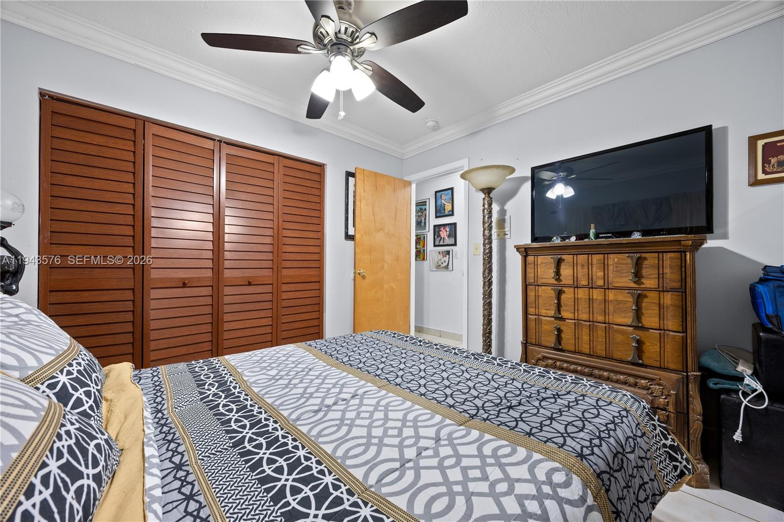 20150 Southwest 89th Court Cutler Bay, FL 33189 - Photo 26 of 48 a bedroom with a bed and a flat screen tv