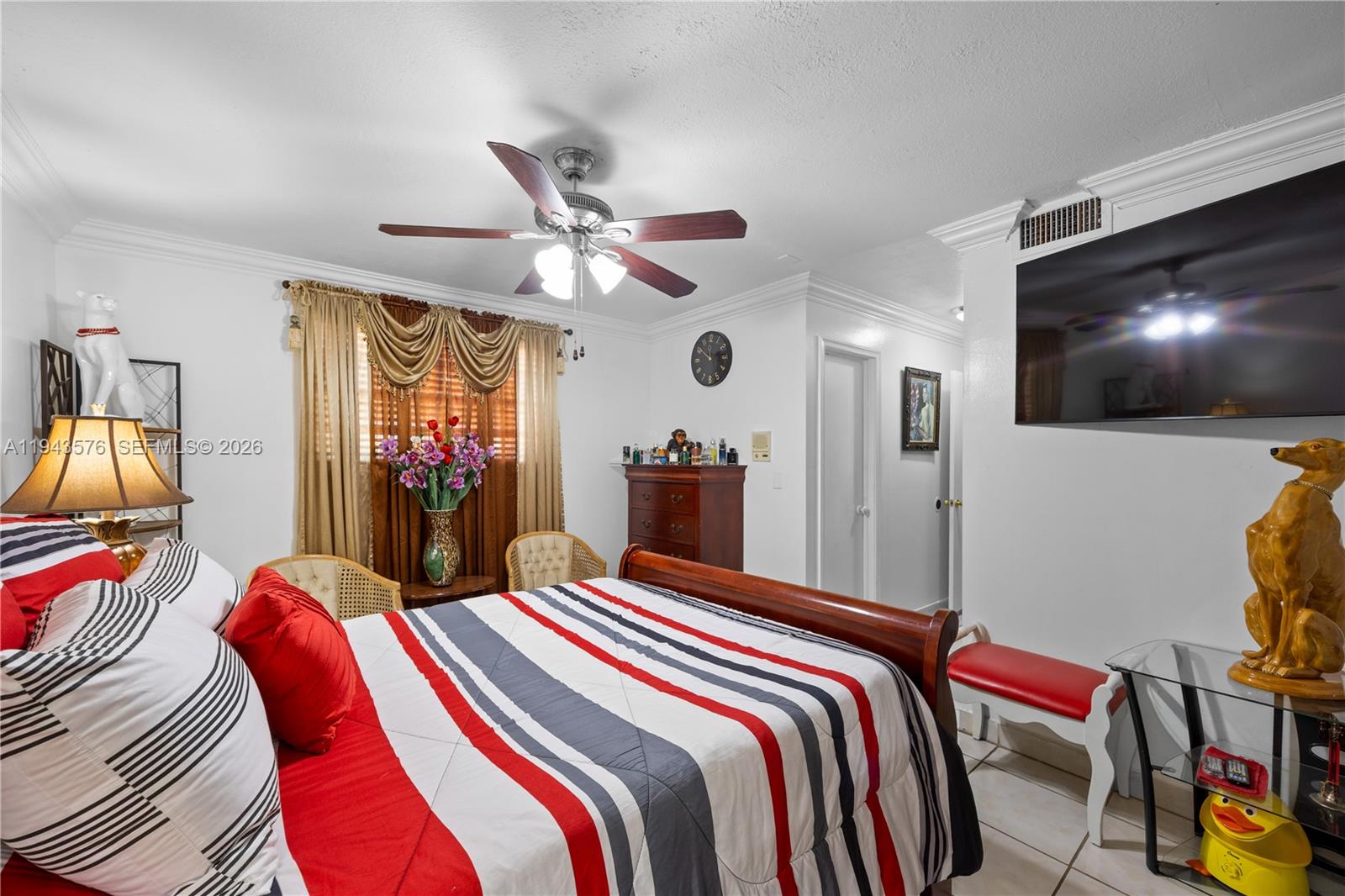 20150 Southwest 89th Court Cutler Bay, FL 33189 - Photo 30 of 48 a bedroom with a bed and a flat screen tv