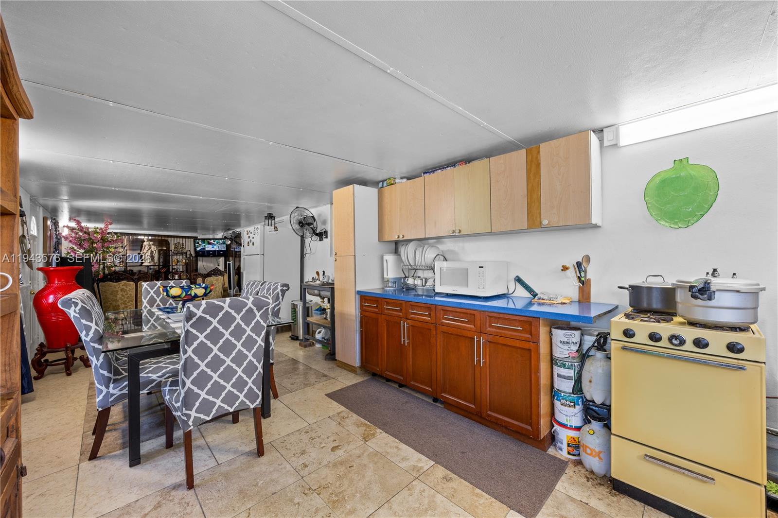 20150 Southwest 89th Court Cutler Bay, FL 33189 - Photo 35 of 48 a kitchen with a dining table chairs and a window