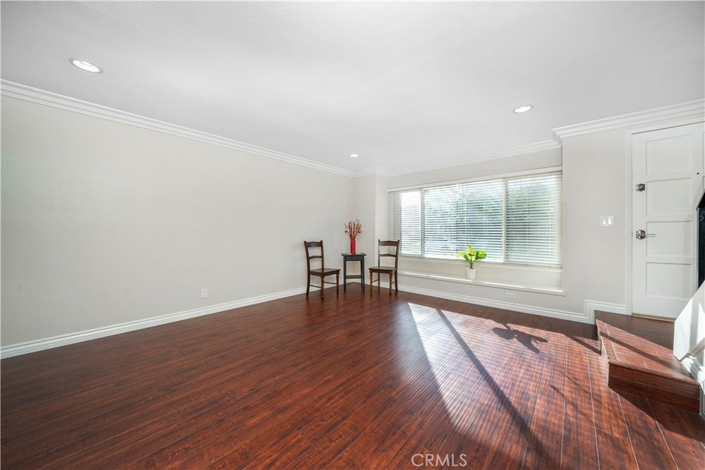 6486 Penn Street, Unit B Moorpark, CA 93021 - Photo 10 of 38 an empty room with wooden floor and a floor to ceiling window
