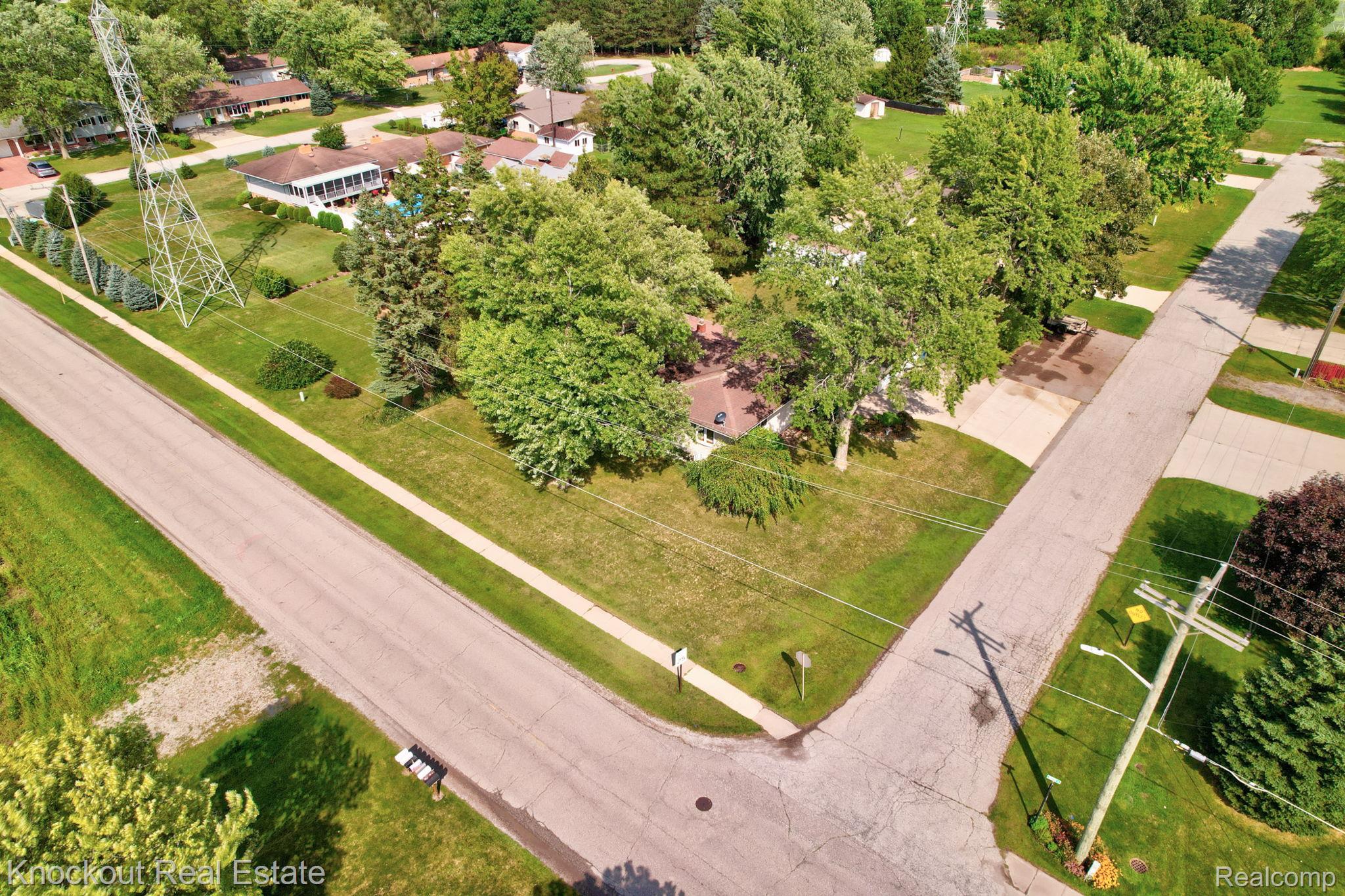 1755 South Reese Road Reese, MI 48757 - Photo 53 of 69 Corner lot property with a private driveway, mature trees, and a manicured lawn