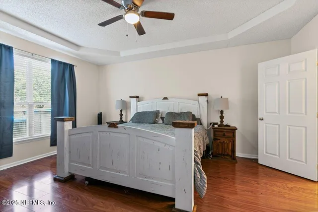 a kitchen with a stove and wooden floor