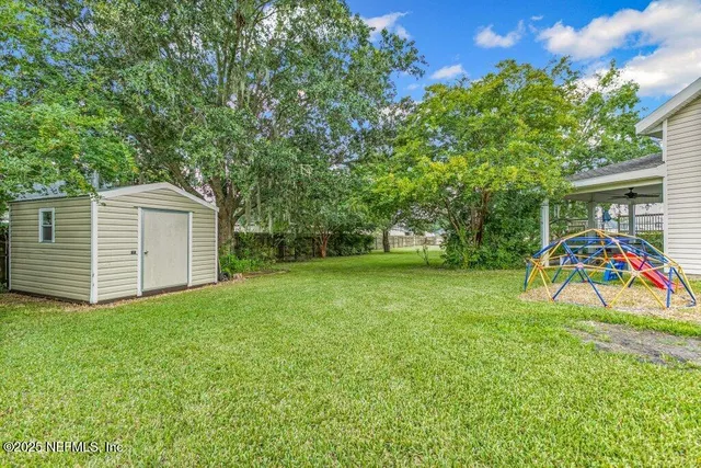 a view of a backyard with a garden and trees