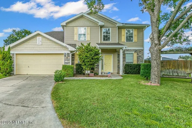 a view of a house with a yard
