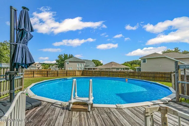 a view of a balcony with swimming pool and furniture