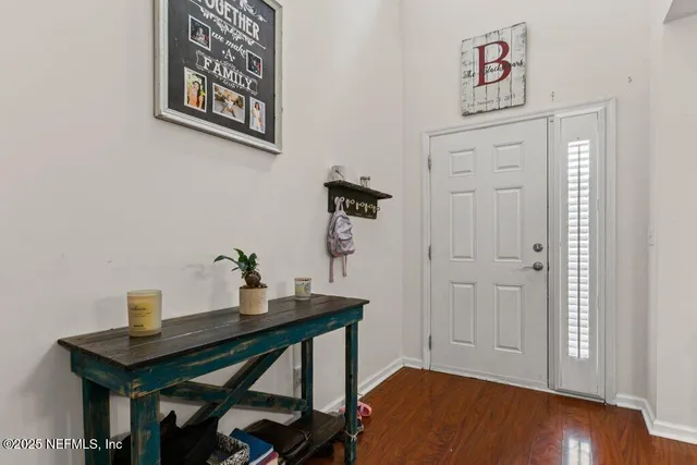 a view of a workspace with furniture and wooden floor