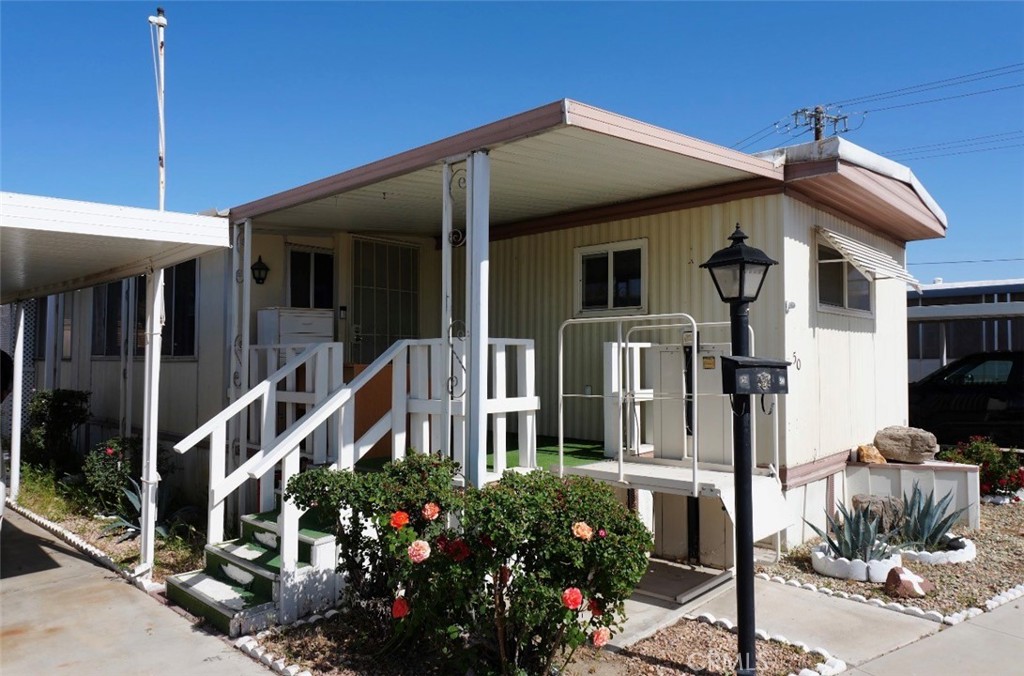 15940 Stoddard Wells Road, Unit 50HWY Victorville, CA 92395 - Photo 1 of 15 a front view of a house with a yard