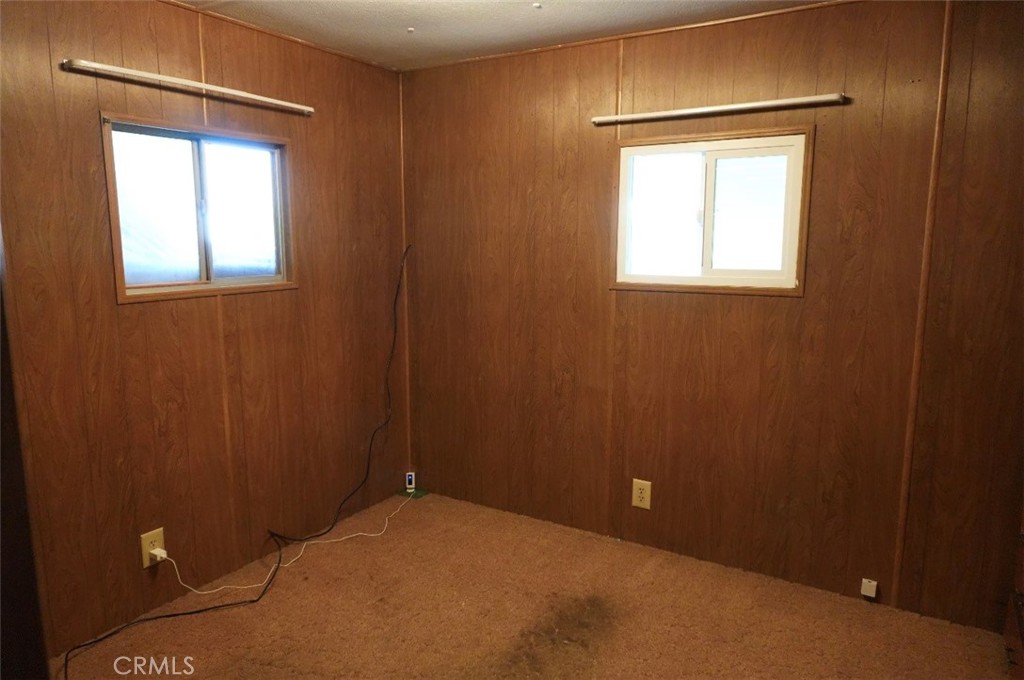 15940 Stoddard Wells Road, Unit 50HWY Victorville, CA 92395 - Photo 12 of 15 a view of an empty room with a window