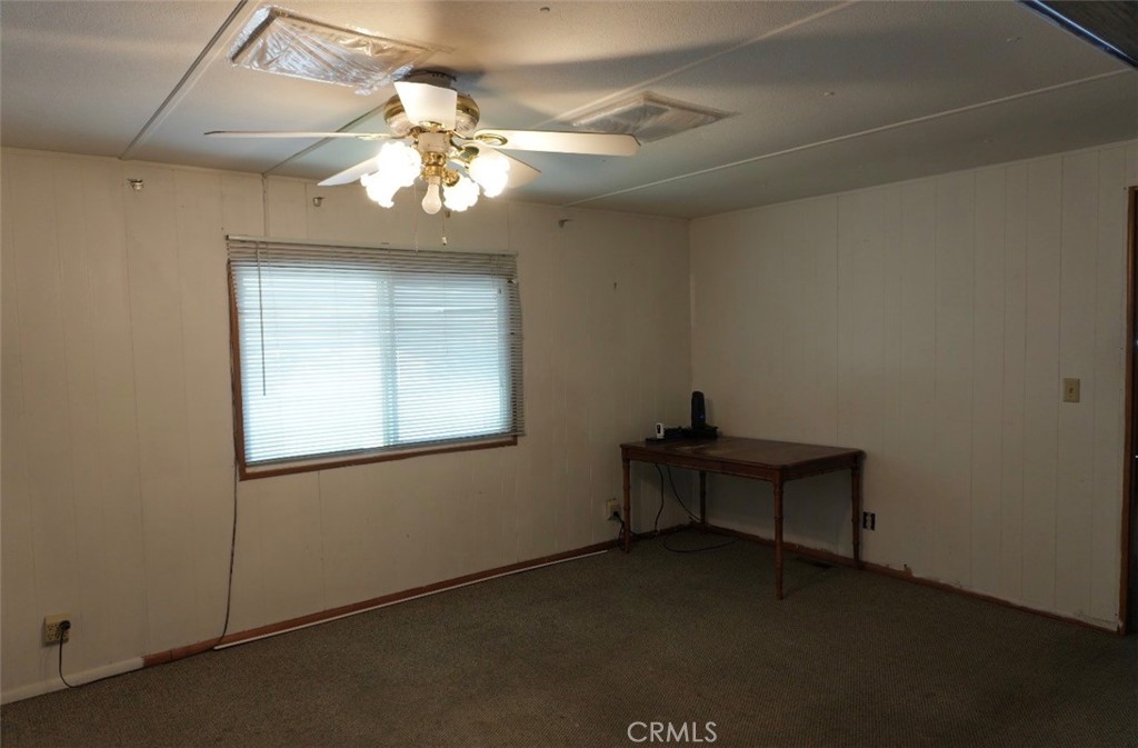 15940 Stoddard Wells Road, Unit 50HWY Victorville, CA 92395 - Photo 14 of 15 a view of a livingroom with a chandelier fan