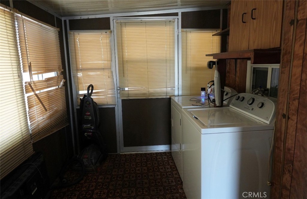 15940 Stoddard Wells Road, Unit 50HWY Victorville, CA 92395 - Photo 6 of 15 a kitchen with a sink and a refrigerator