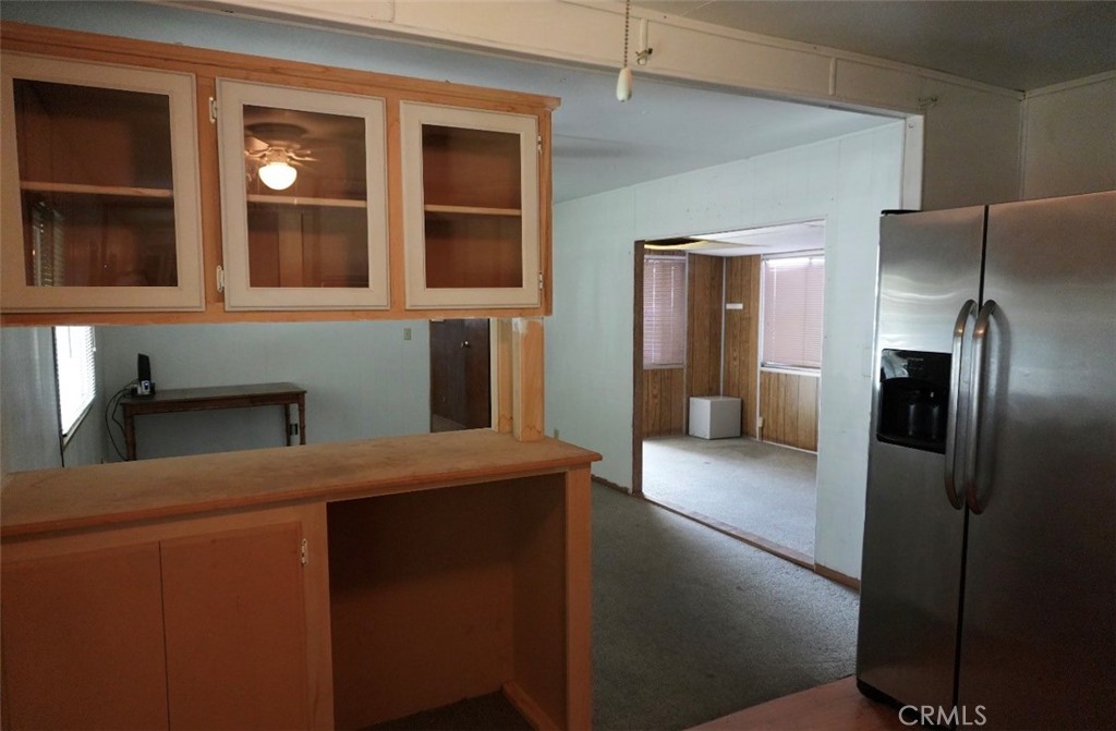 15940 Stoddard Wells Road, Unit 50HWY Victorville, CA 92395 - Photo 8 of 15 a kitchen with stainless steel appliances granite countertop a refrigerator and a sink