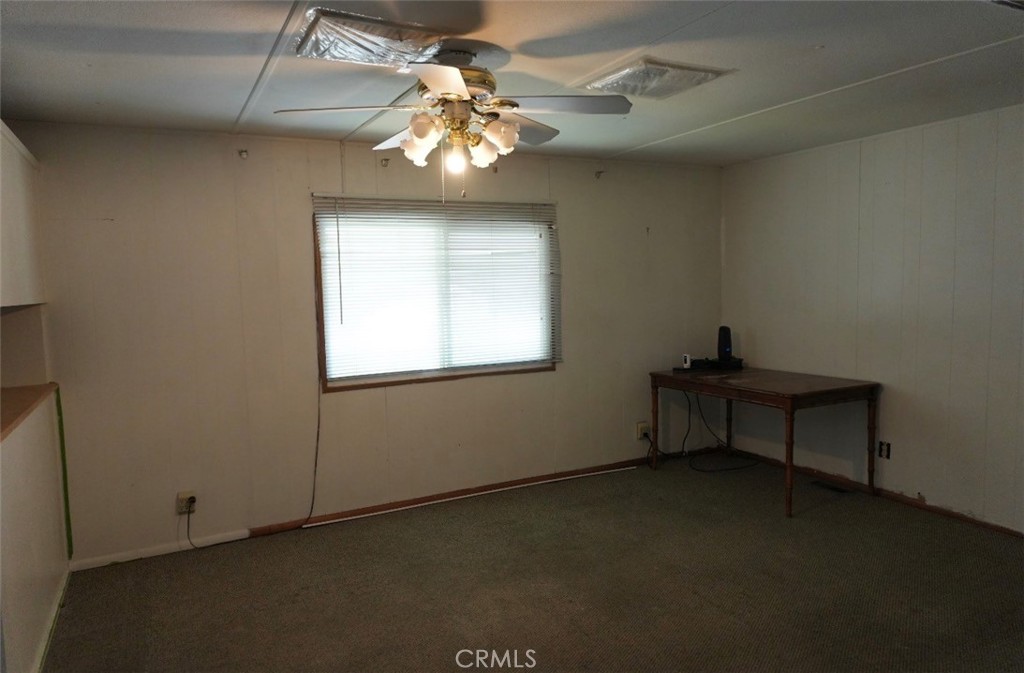 15940 Stoddard Wells Road, Unit 50HWY Victorville, CA 92395 - Photo 10 of 15 an empty room with a window