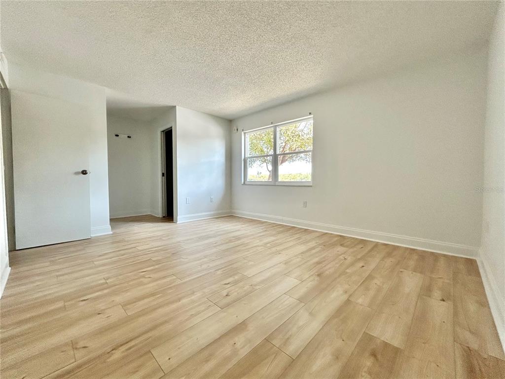 247 South McMullen Booth Road, Unit 23 Clearwater, FL 33759 - Photo 16 of 47 an empty room with wooden floor and windows