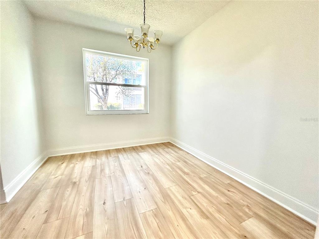 247 South McMullen Booth Road, Unit 23 Clearwater, FL 33759 - Photo 22 of 47 a view of an empty room with wooden floor and a window