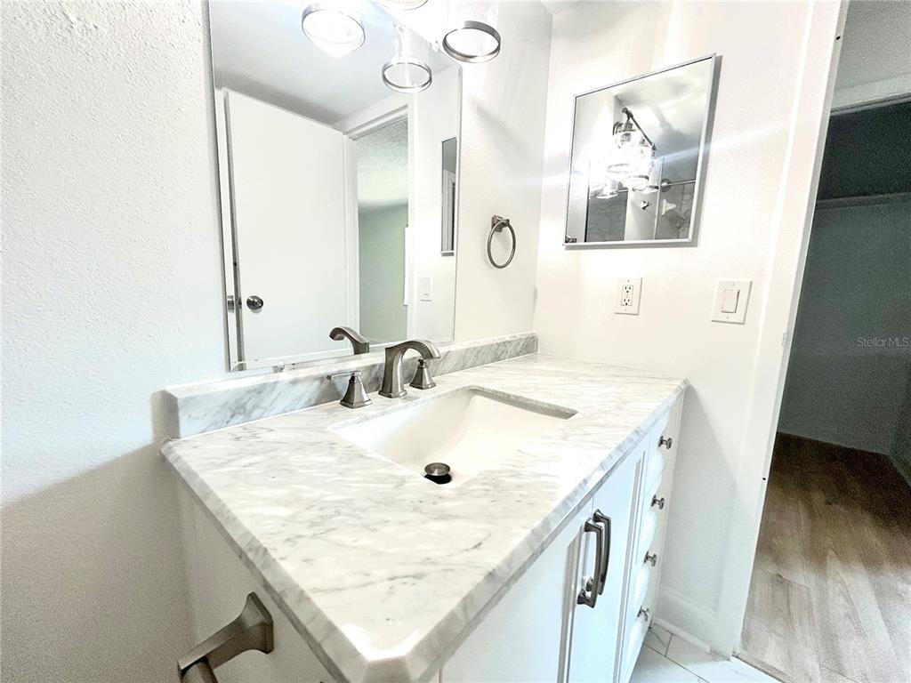 247 South McMullen Booth Road, Unit 23 Clearwater, FL 33759 - Photo 26 of 47 a bathroom with a sink and a mirror