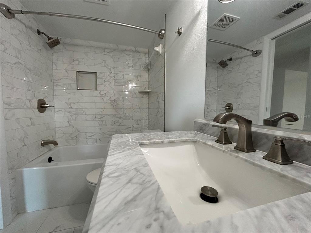 247 South McMullen Booth Road, Unit 23 Clearwater, FL 33759 - Photo 27 of 47 a bathroom with a tub sink a mirror and shower