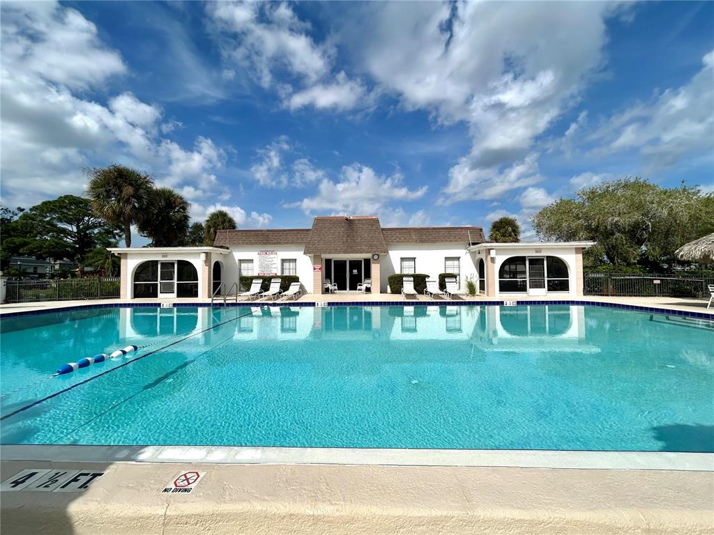 247 South McMullen Booth Road, Unit 23 Clearwater, FL 33759 - Photo 35 of 47 a front view of a house with a garden