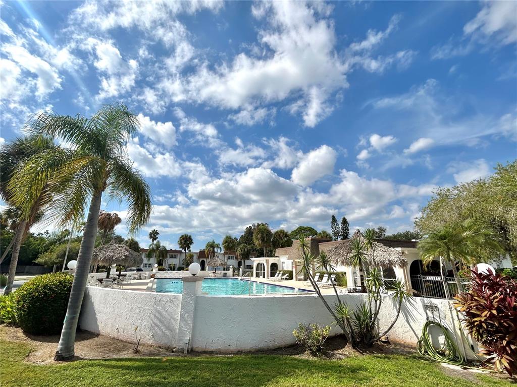 247 South McMullen Booth Road, Unit 23 Clearwater, FL 33759 - Photo 37 of 47 a view of a house with swimming pool and sitting area