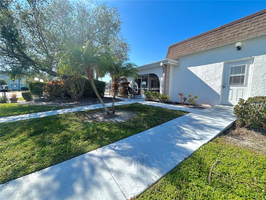 247 South McMullen Booth Road, Unit 23 Clearwater, FL 33759 - Photo 43 of 47 a front view of a house with garden