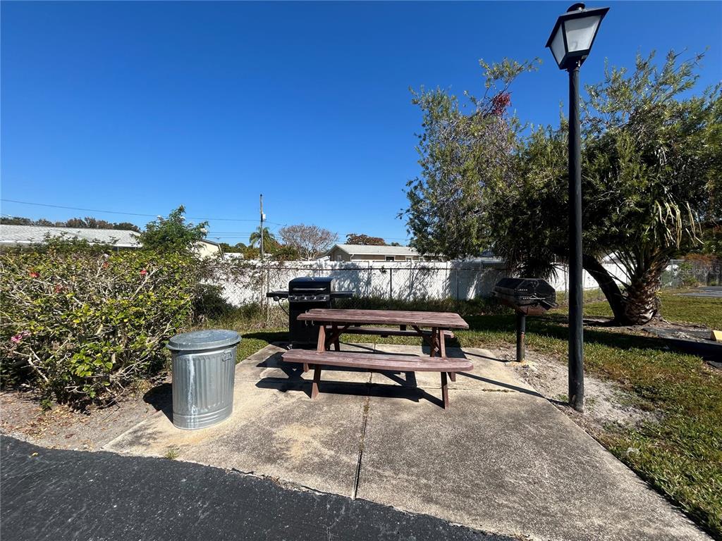 247 South McMullen Booth Road, Unit 23 Clearwater, FL 33759 - Photo 44 of 47 a view of a bench in a backyard