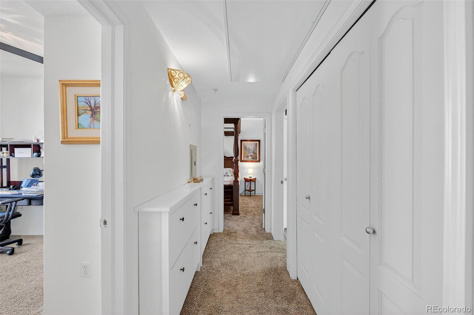 18611 Stroh Road, Unit 5203 Parker, CO 80134 - Photo 11 of 24 a view of a hallway with wooden shelves