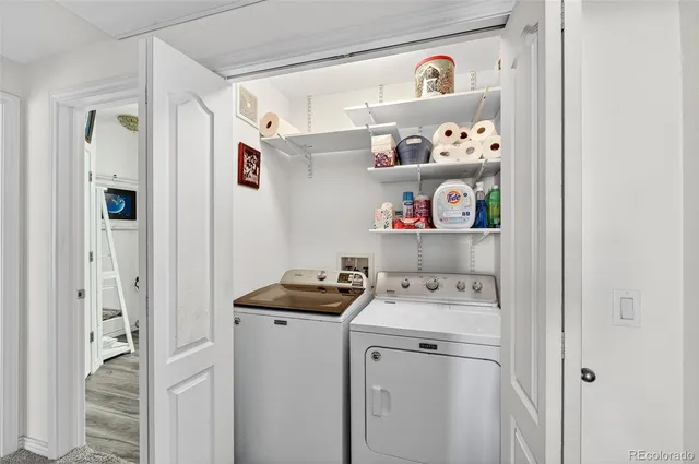 a utility room with fridge dryer and washer
