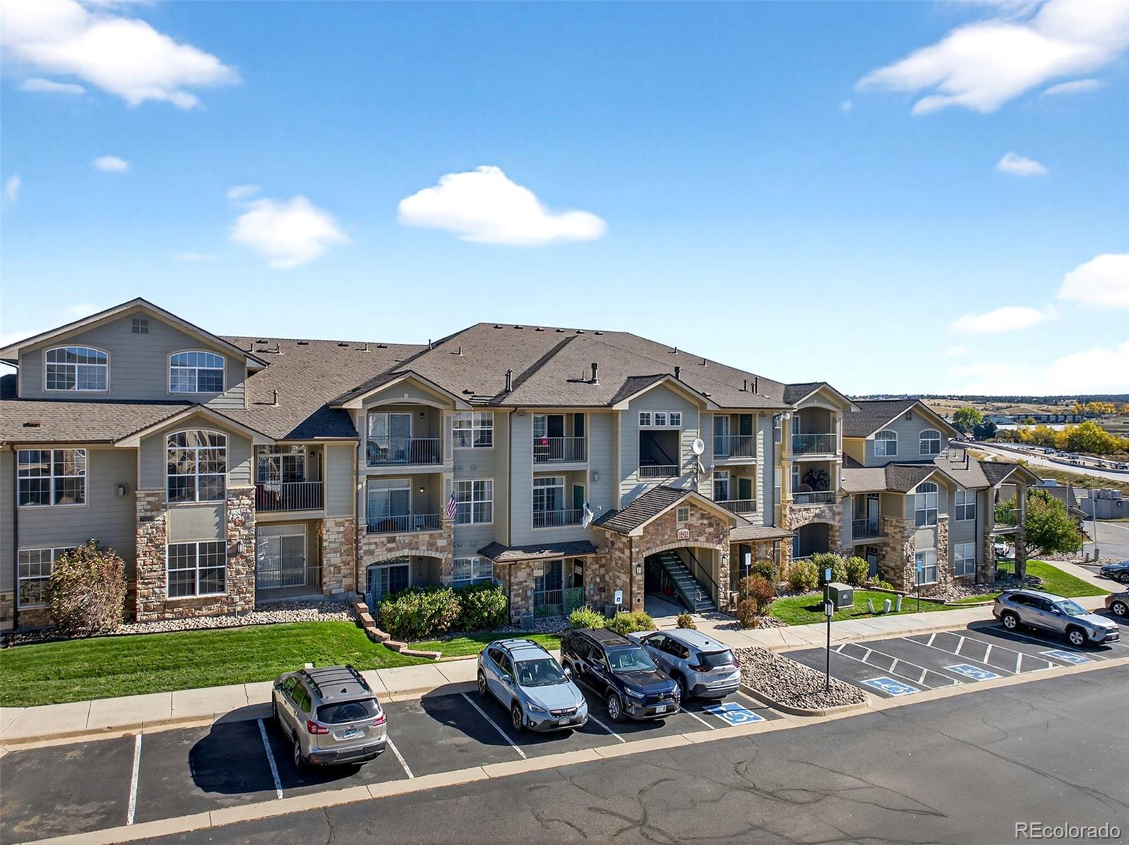18611 Stroh Road, Unit 5203 Parker, CO 80134 - Photo 18 of 24 a front view of a house with garden and porch