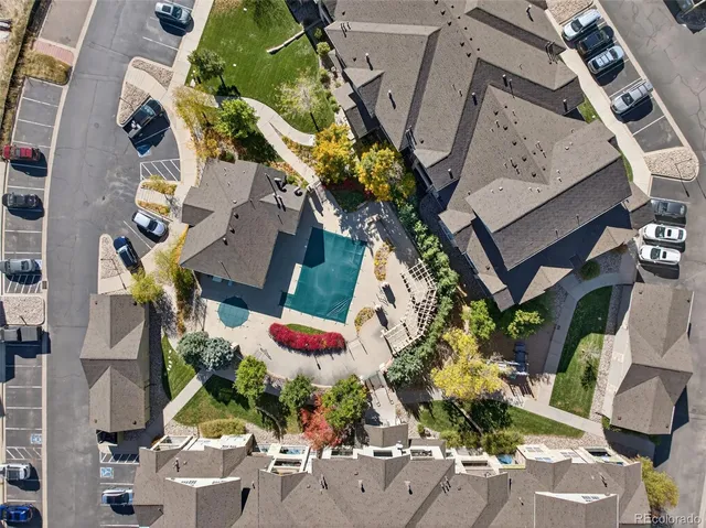 an aerial view of a house with a yard and a fountain
