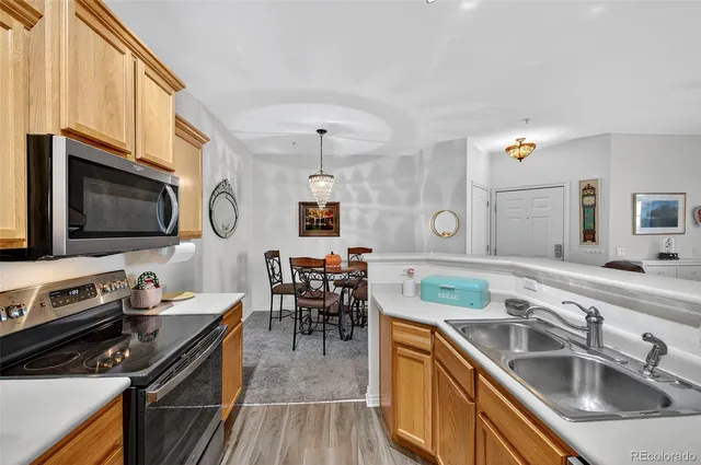 a kitchen with a sink appliances and cabinets