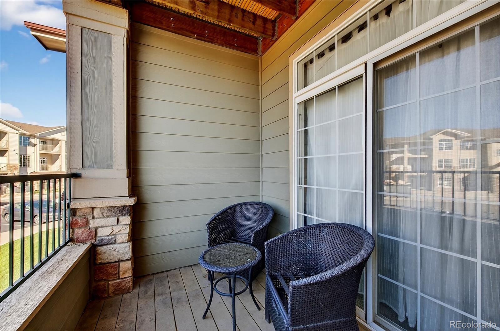 18611 Stroh Road, Unit 5203 Parker, CO 80134 - Photo 8 of 24 a living room with furniture and wooden floor