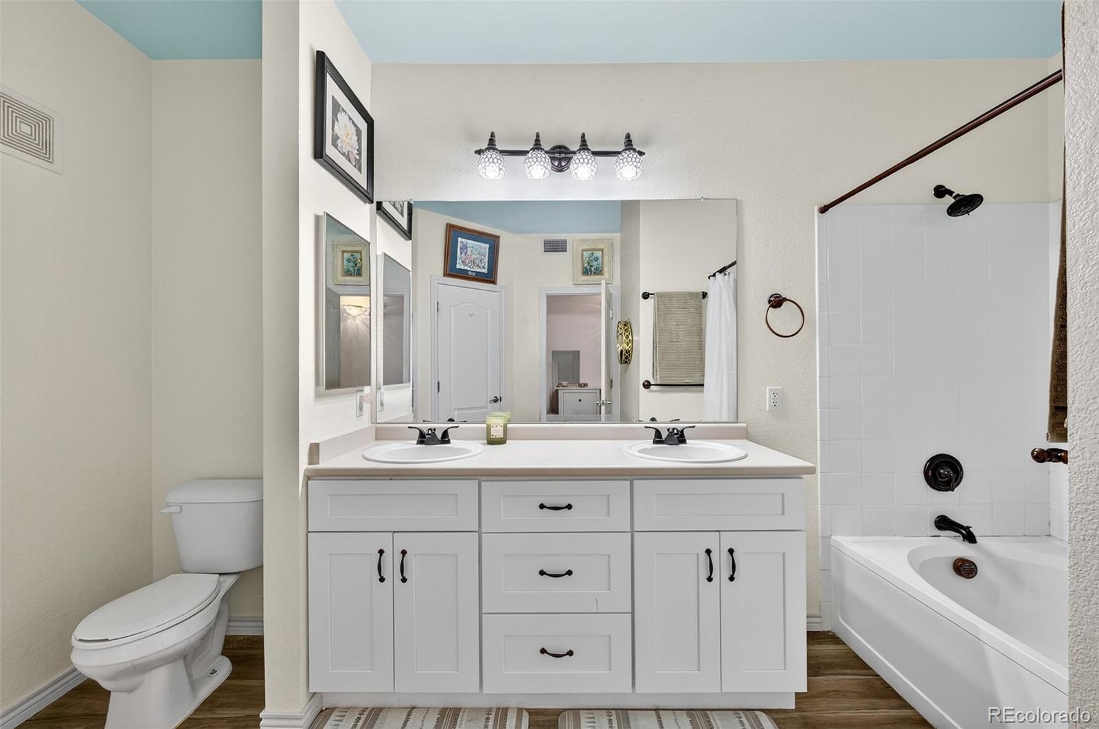 18611 Stroh Road, Unit 5203 Parker, CO 80134 - Photo 9 of 24 a bathroom with a double vanity sink mirror and toilet