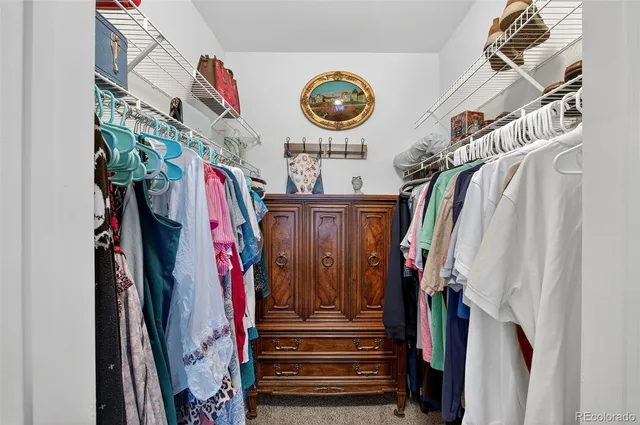 a view of walk in closet with clothes
