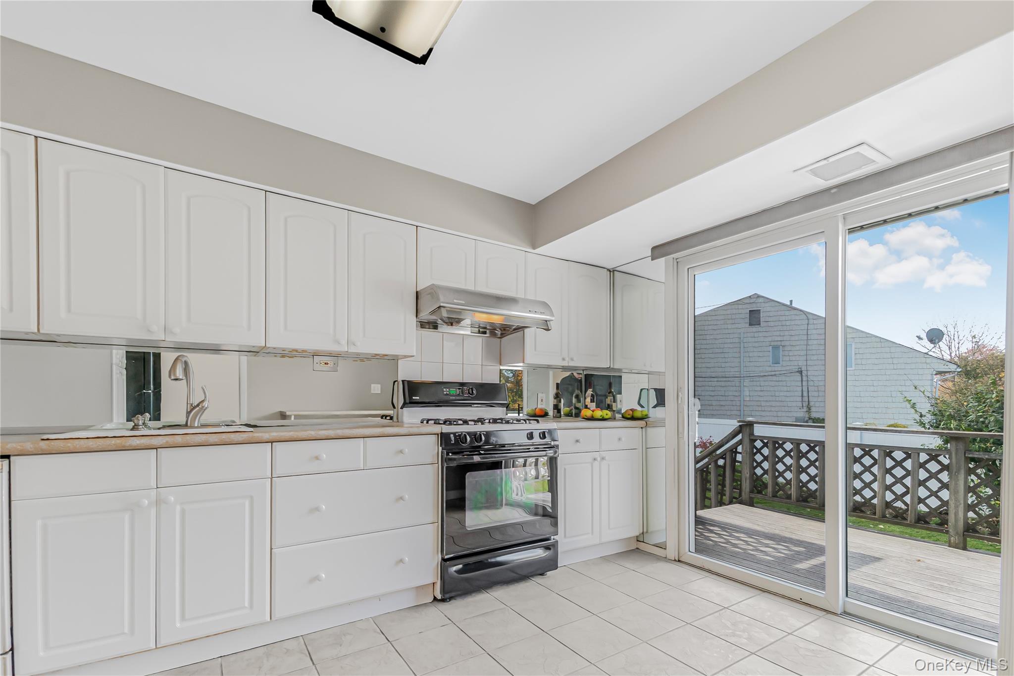 2 Deer Path Lane Syosset, NY 11791 - Photo 13 of 41 a kitchen with cabinets and appliances