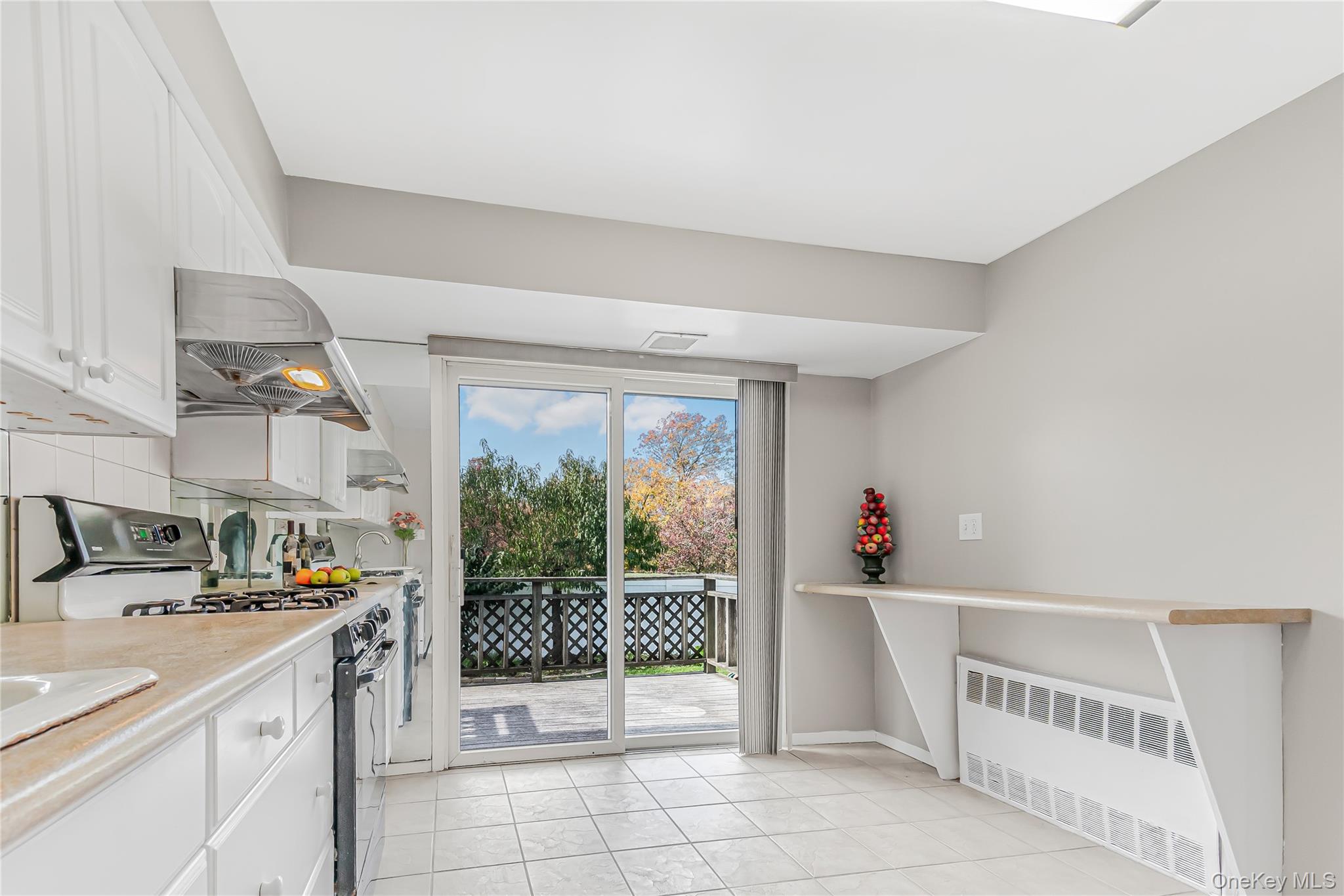 2 Deer Path Lane Syosset, NY 11791 - Photo 14 of 41 a open kitchen with stainless steel appliances a sink and cabinets