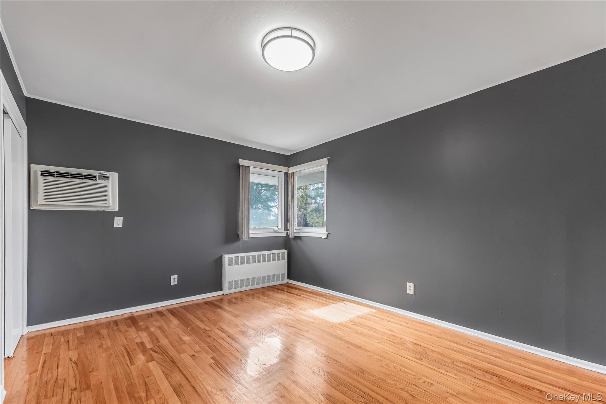 2 Deer Path Lane Syosset, NY 11791 - Photo 29 of 41 a bedroom with a bed and a window