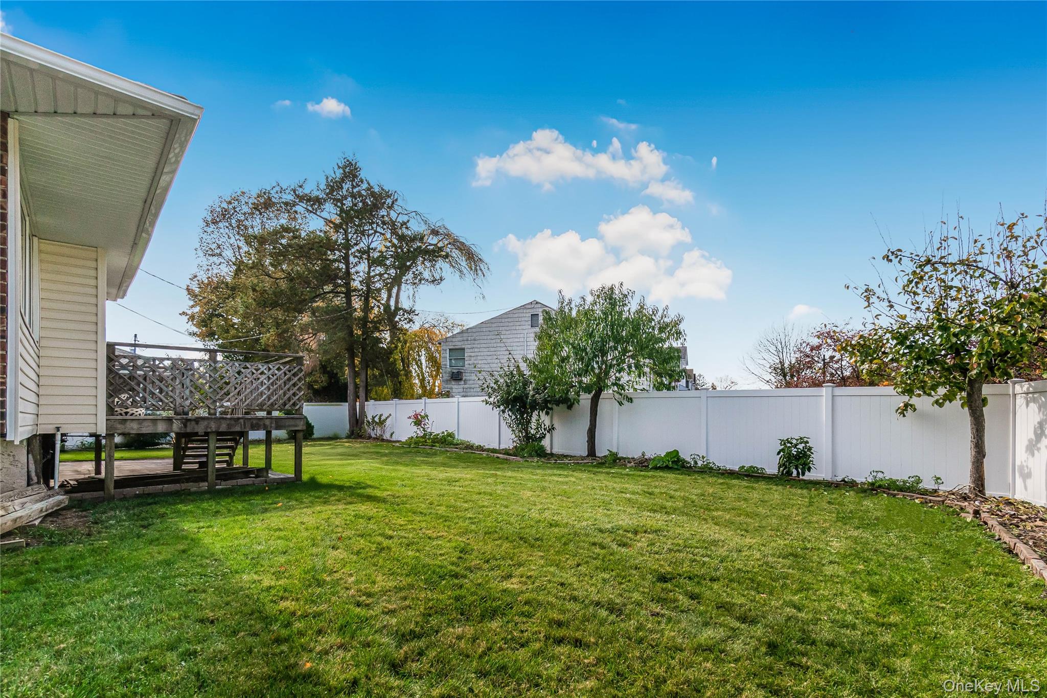 2 Deer Path Lane Syosset, NY 11791 - Photo 36 of 41 a view of a backyard with sitting area