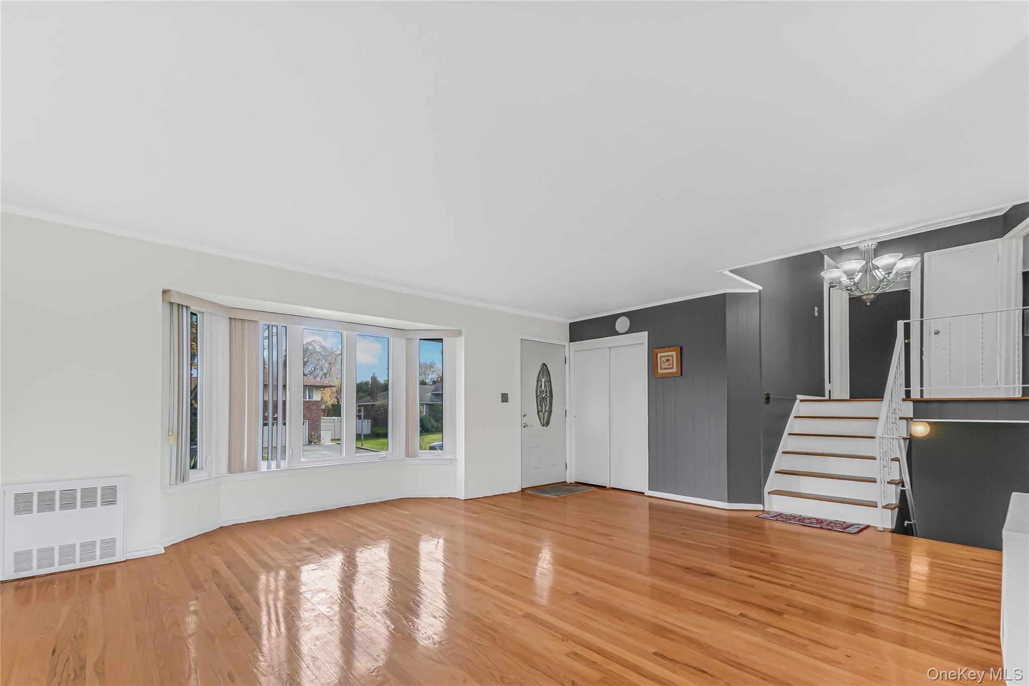 2 Deer Path Lane Syosset, NY 11791 - Photo 6 of 41 a view of an empty room with wooden floor and stairs