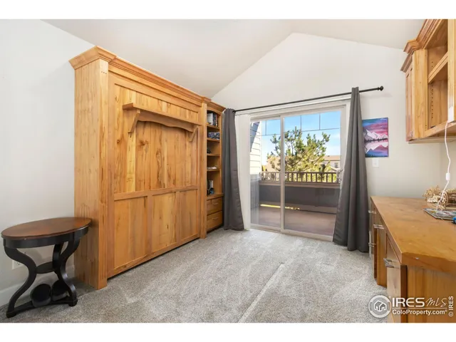 a view of hallway with furniture and a window