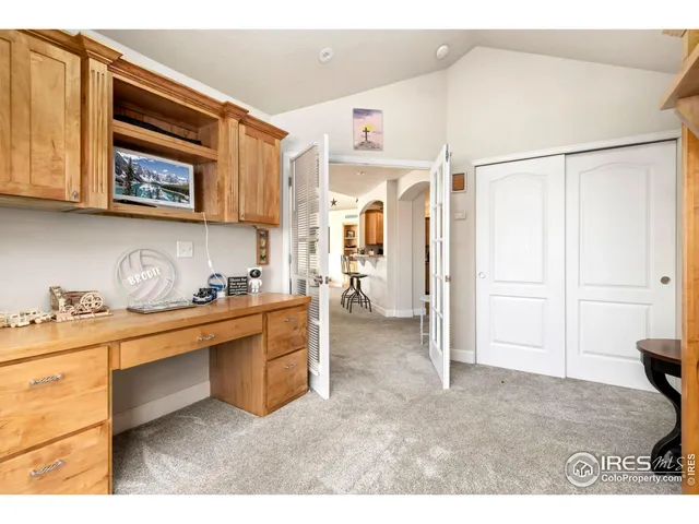 a living room with stainless steel appliances kitchen island granite countertop a refrigerator and cabinets