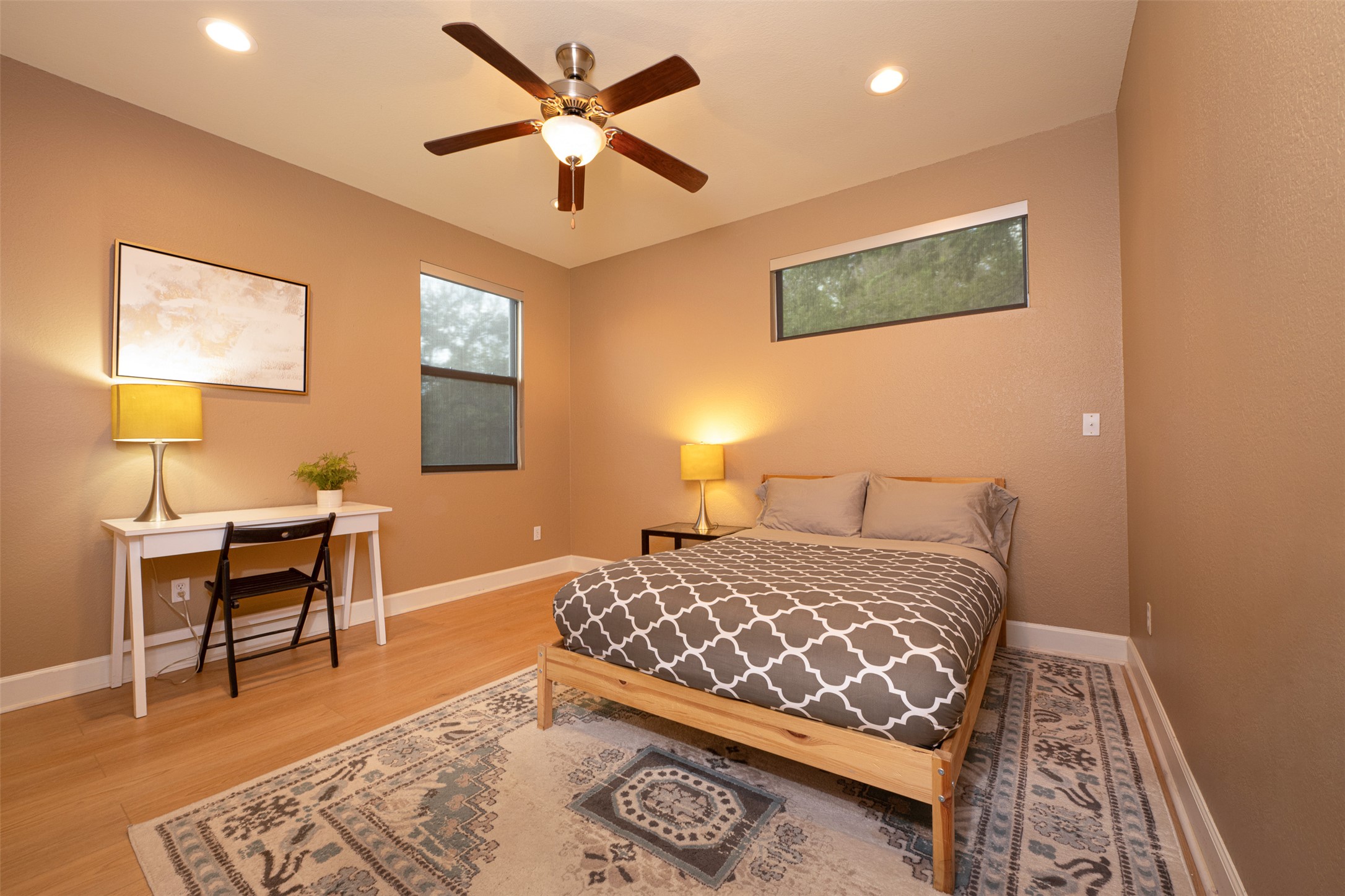 2302 East 9th Street Austin, TX 78702 - Photo 23 of 31 A tranquil sleeping space featuring a ceiling fan and rich hardwood flooring.