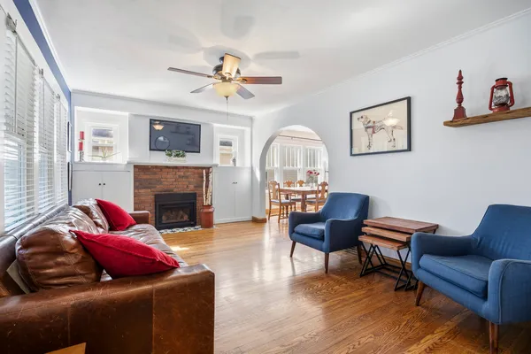 a living room with furniture and wooden floor