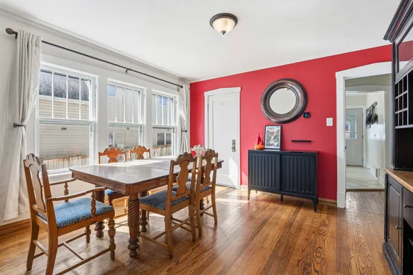 a view of a dining room with furniture and wooden floor