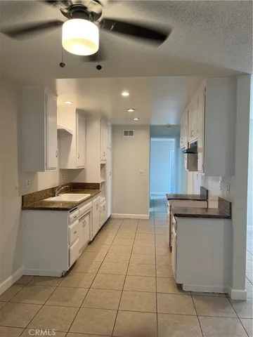 a large kitchen with stainless steel appliances granite countertop a stove and a sink