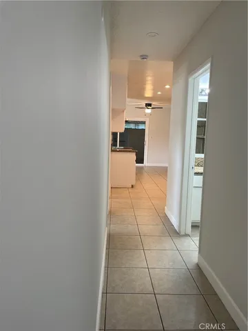 a view of a hallway with a kitchen