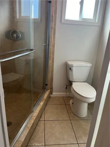a bathroom with a toilet and a shower