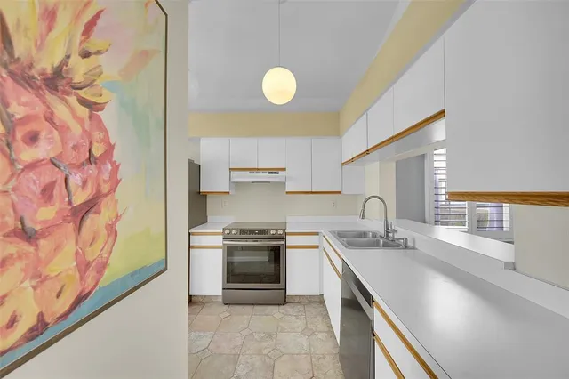 a kitchen with a sink stove and cabinets