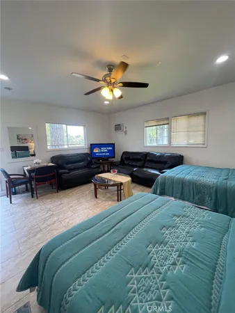 a living room with furniture and a chandelier