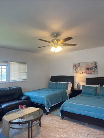 a bedroom with furniture and a chandelier