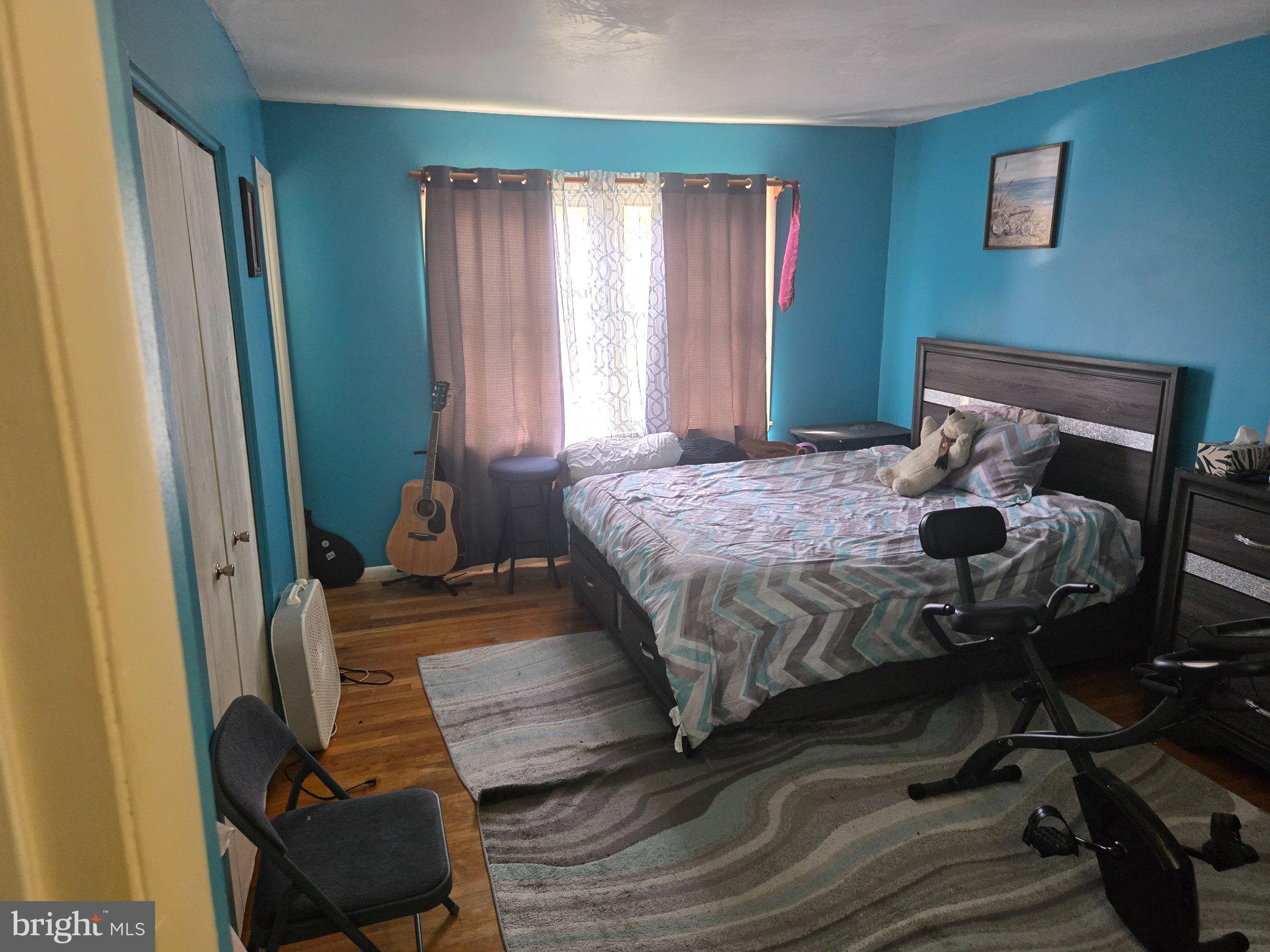 9401 Pine View Lane Clinton, MD 20735 - Photo 7 of 15 a bedroom with a bed and wooden floor