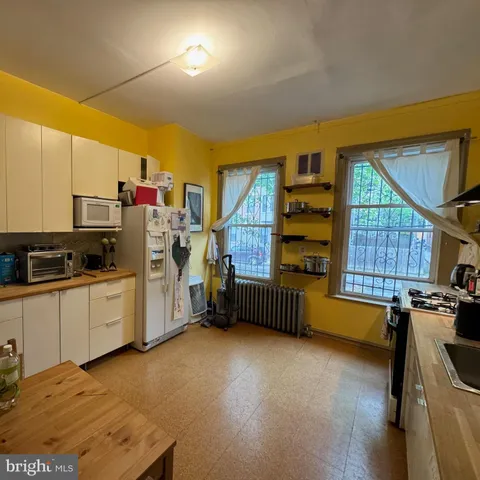 a kitchen with refrigerator and cabinets